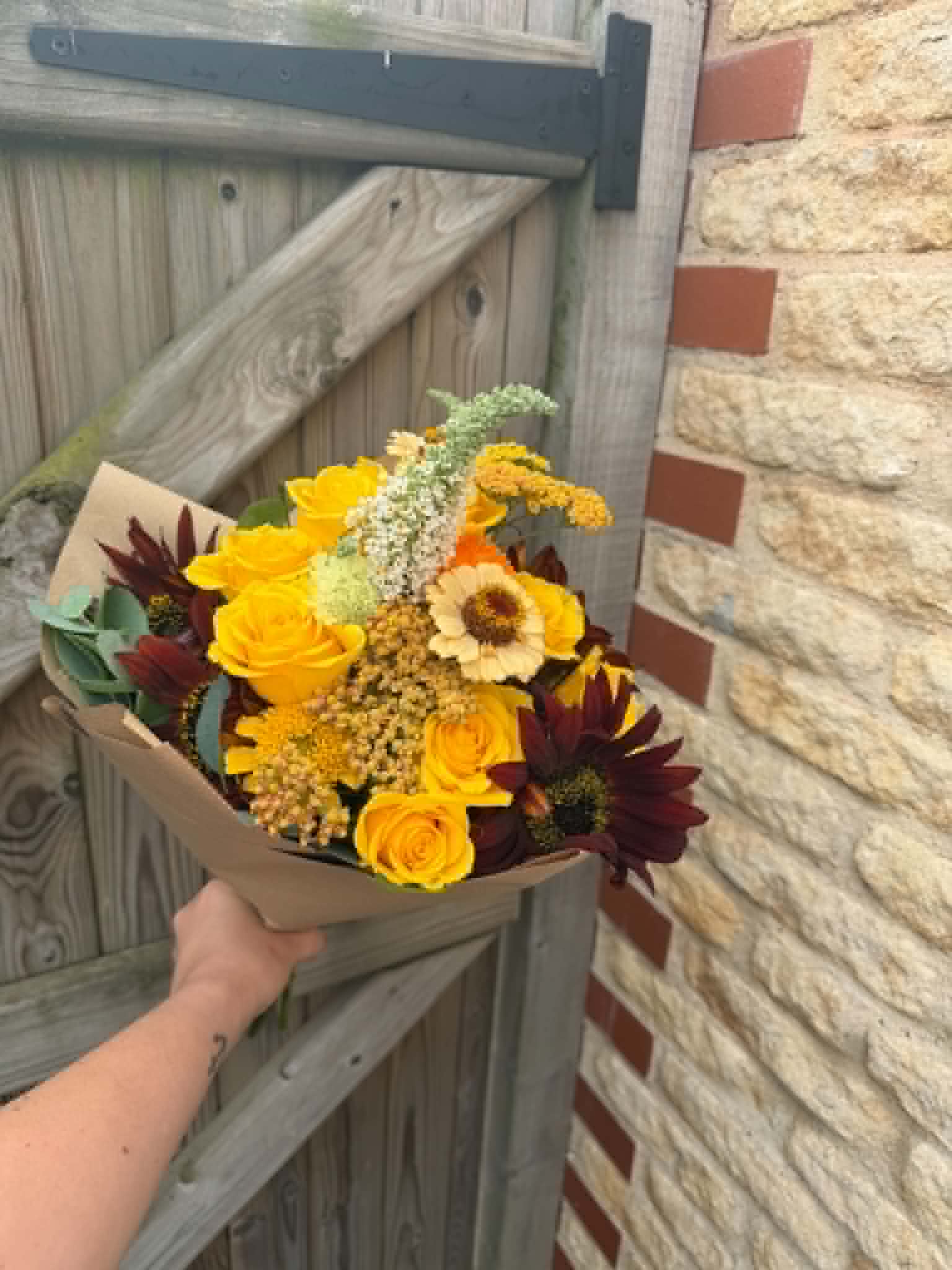 Autumn hand-tied bouquet wrapped in kraft paper