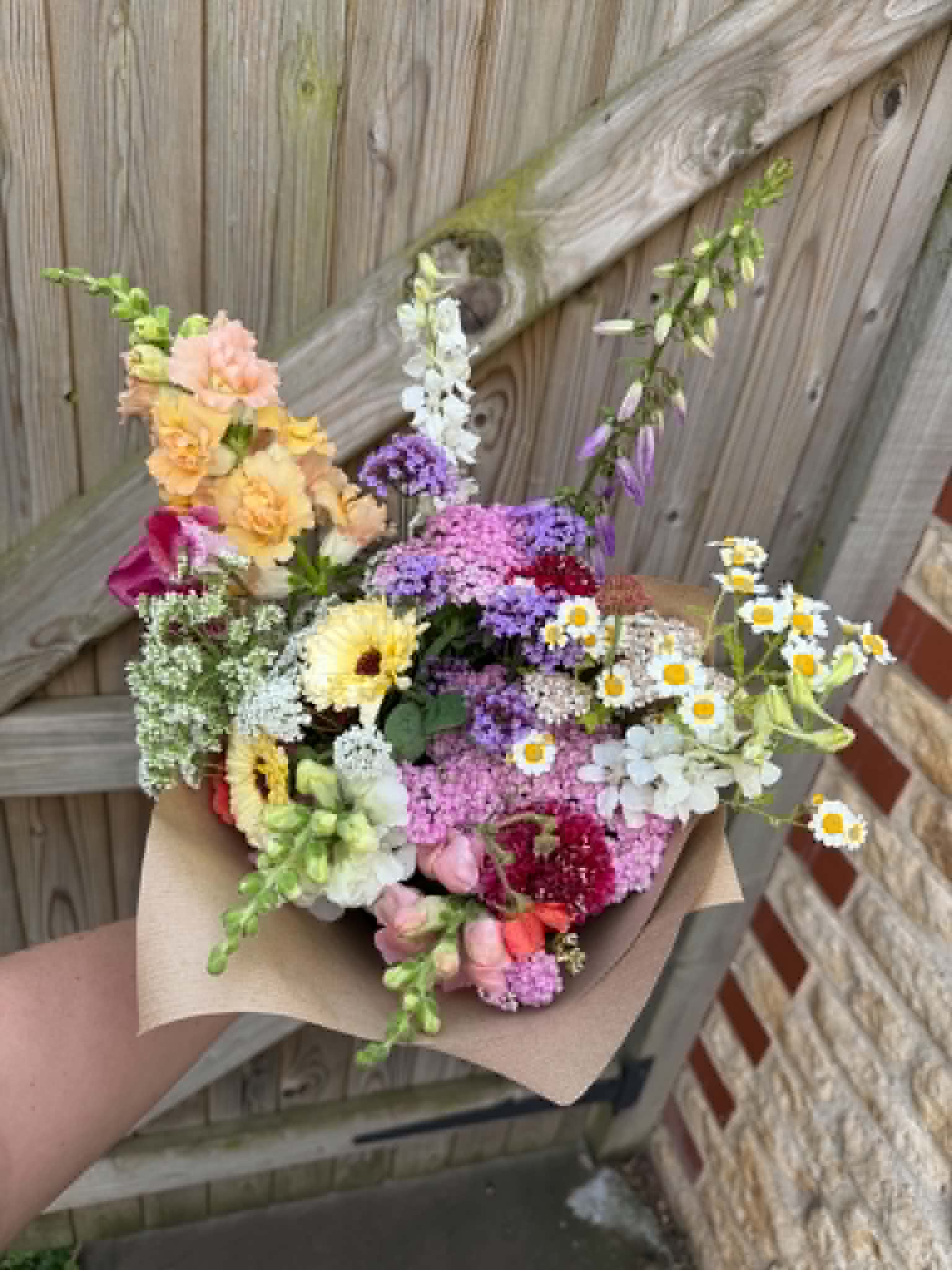 Colourful seasonal bouquet wrapped in kraft paper